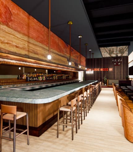 Interior of a stylish bar with a long marble countertop, high stools, warm wood paneling, and hanging globe lights