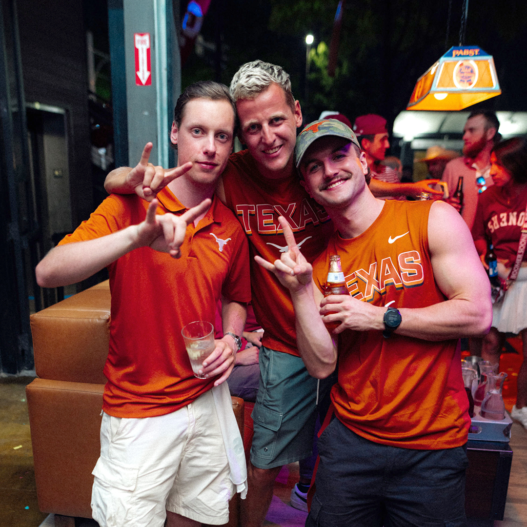 Three Texas Long Horns Fans Celebrating at Palomino Ranch