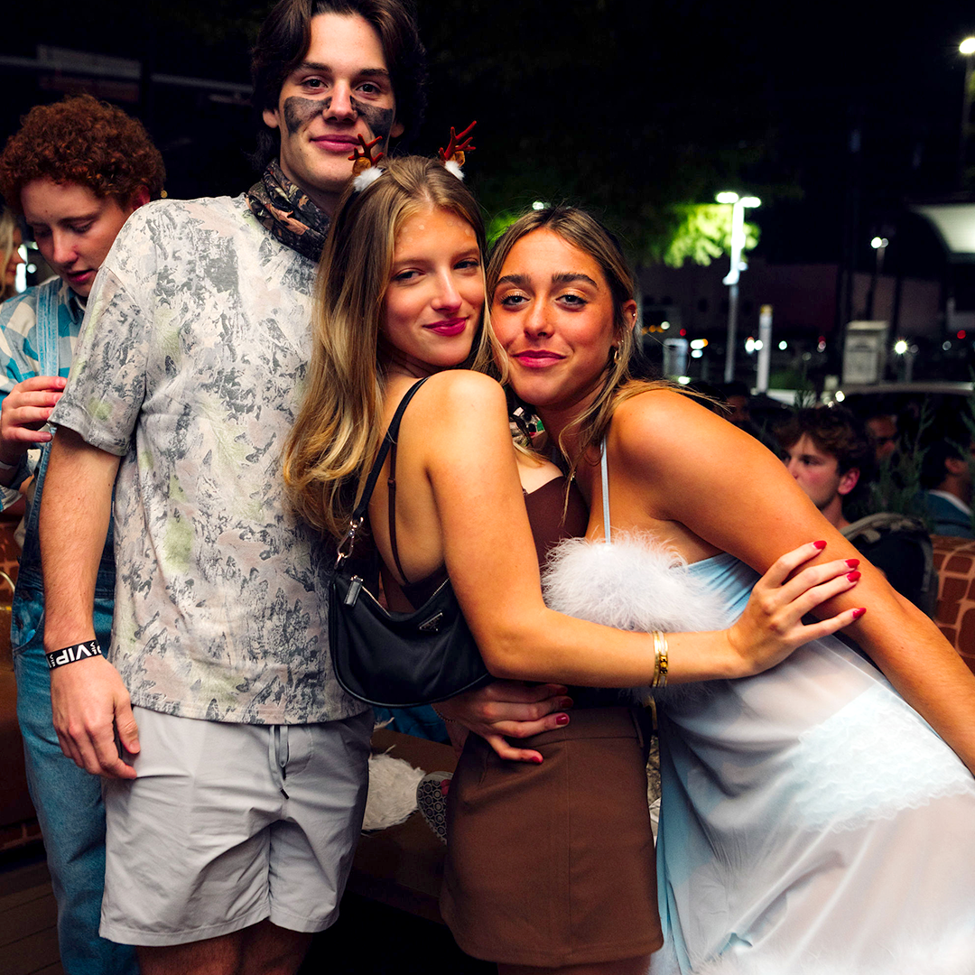 Three people dressed up in costumes celebrating Halloween on the Palomino Ranch roof top